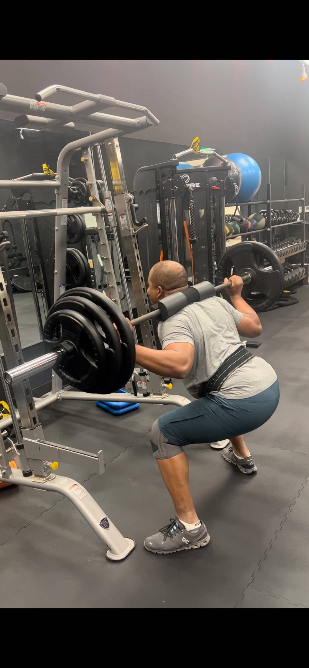 JCBPT-Personal trainer-Houston-Affordable-Personal-Trainer Client squatting 205 lbs with barbell